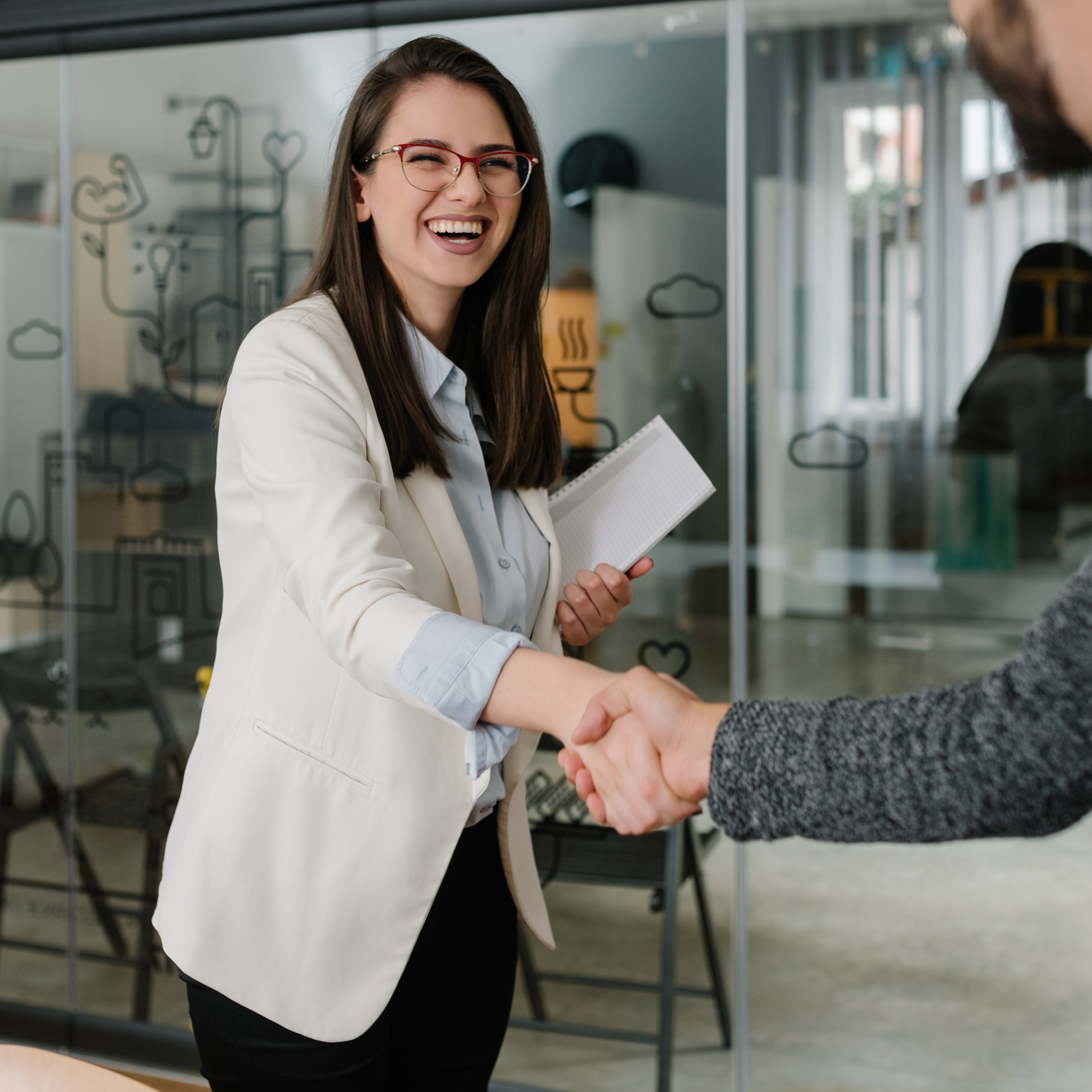 Woman shaking hands in office